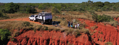 People waving in outback scene